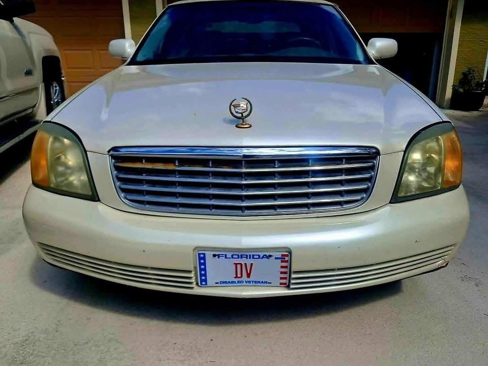 White Cadillac with cloudy headlights before restoration